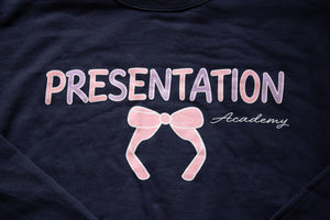 Navy blue shirt with 'PRESENTATION Academy' text and pink bow.